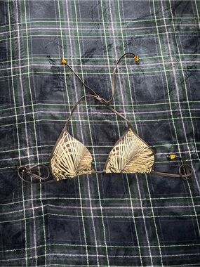Black and white bikini top with leaf pattern and beads at end of ties. Size M.